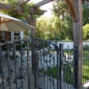 Iron gate with redwood pergola